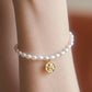 Freshwater pearls bracelet with angel charm