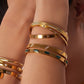 gold bangles on model C&L Jewellery