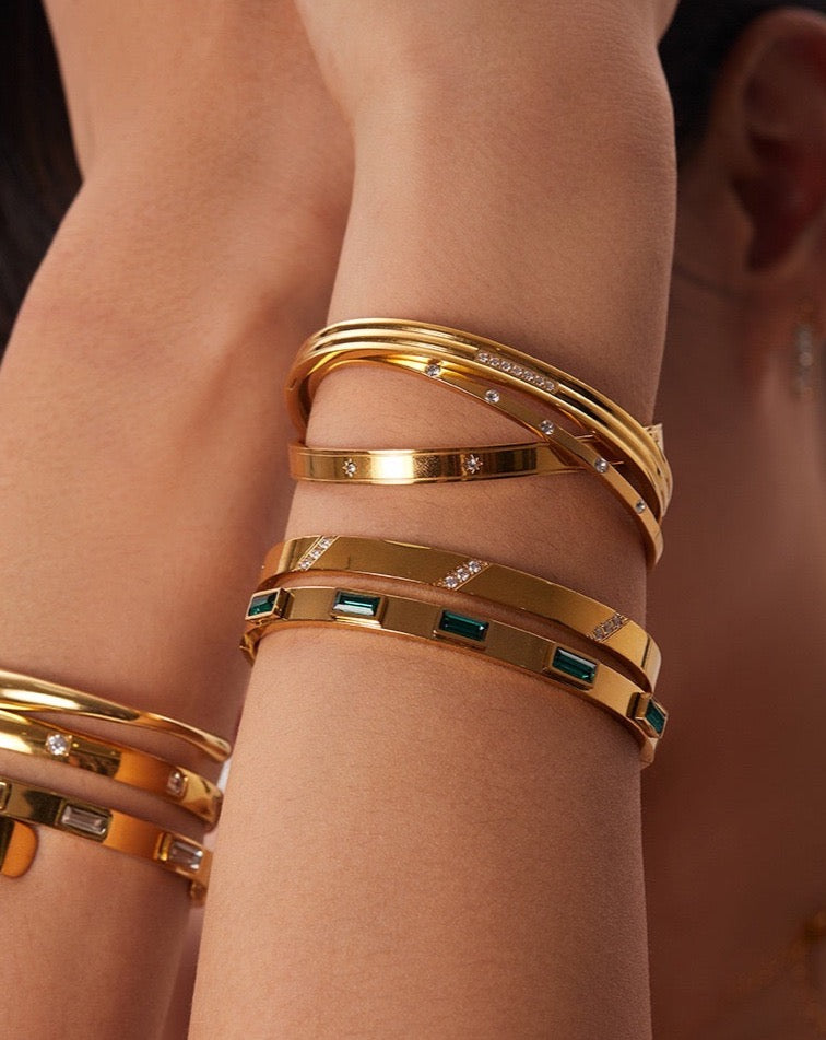gold bangles on model C&L Jewellery
